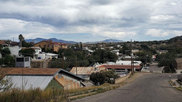 Residential road with older buildings.